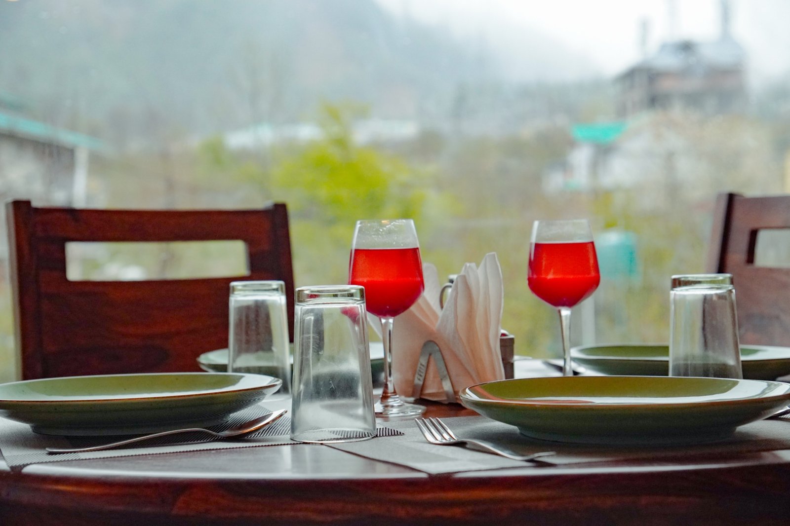 The dining table laid for lunch, mountains in the window