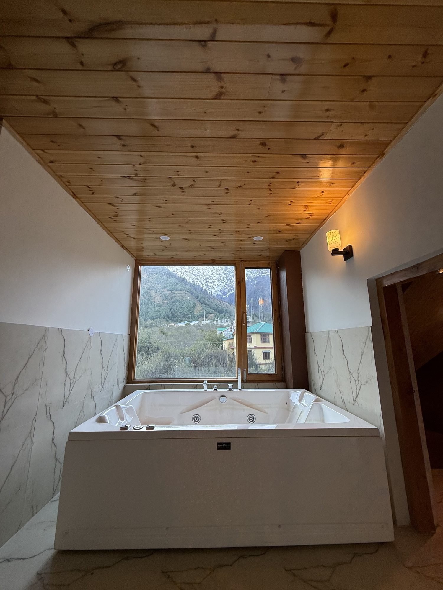 Jacuzzi with a window to the mountains