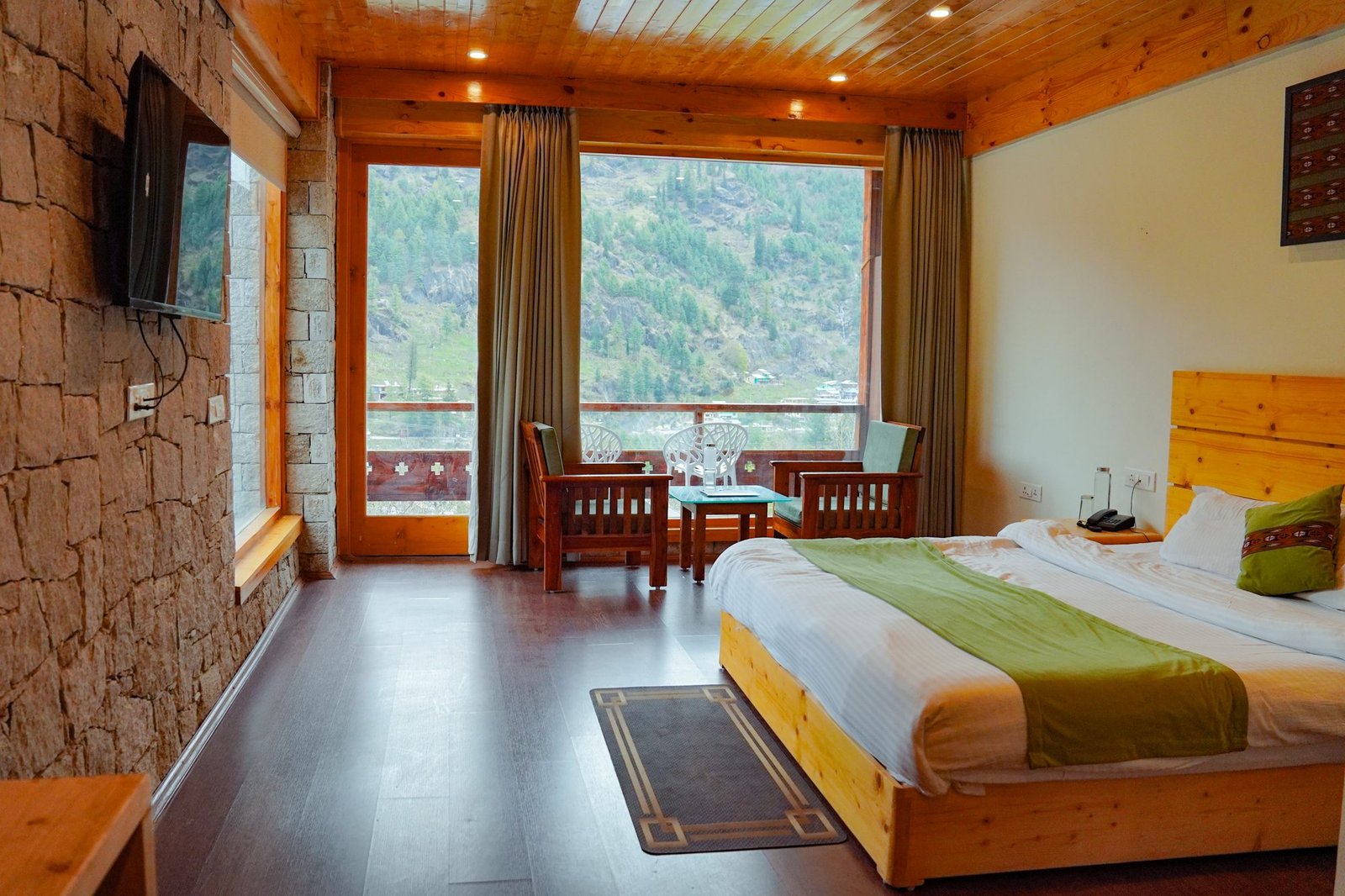 Stone wall, pine ceiling, and the valley in the window