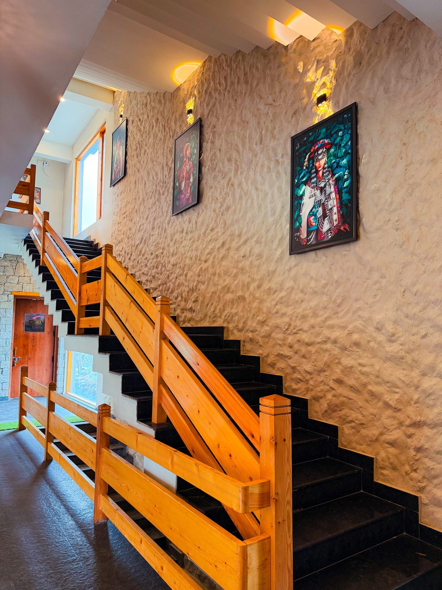 The staircase, hung with paintings