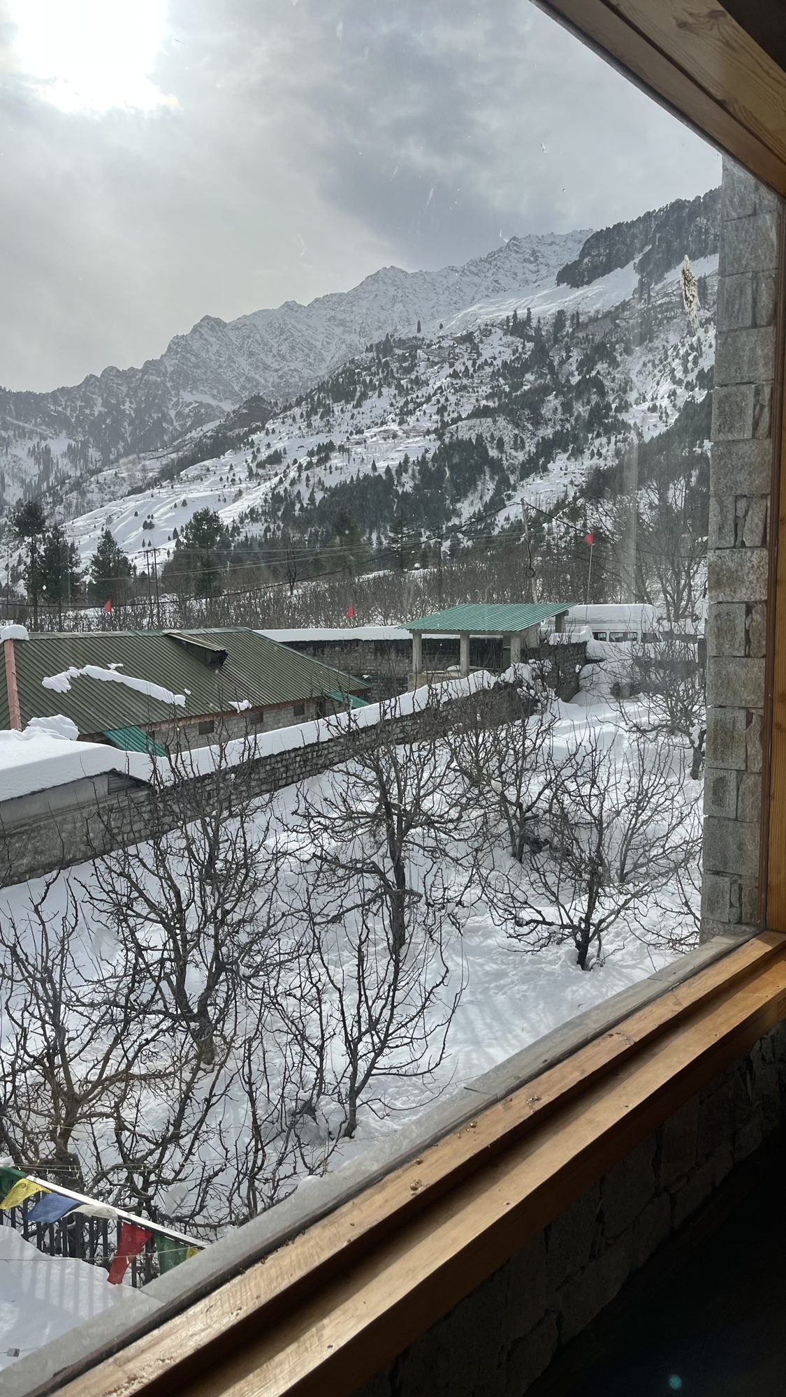 Snow peaks from a room window